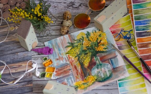 Stół, na którym znajduje się namalowany obraz żółtych kwiatów w wazonie